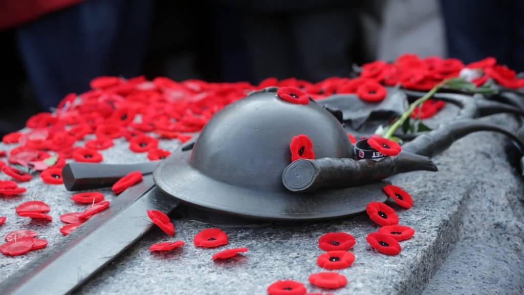 Canadian WW1 helmet and Remembrance PoppiesDescription generated with very high confidence
